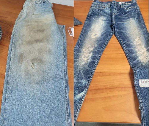 Finished denim jeans with different light and dark wash effects after washing.
