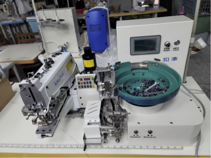 Wide view of a garment manufacturing workshop with multiple sewing workstations and production in progress.